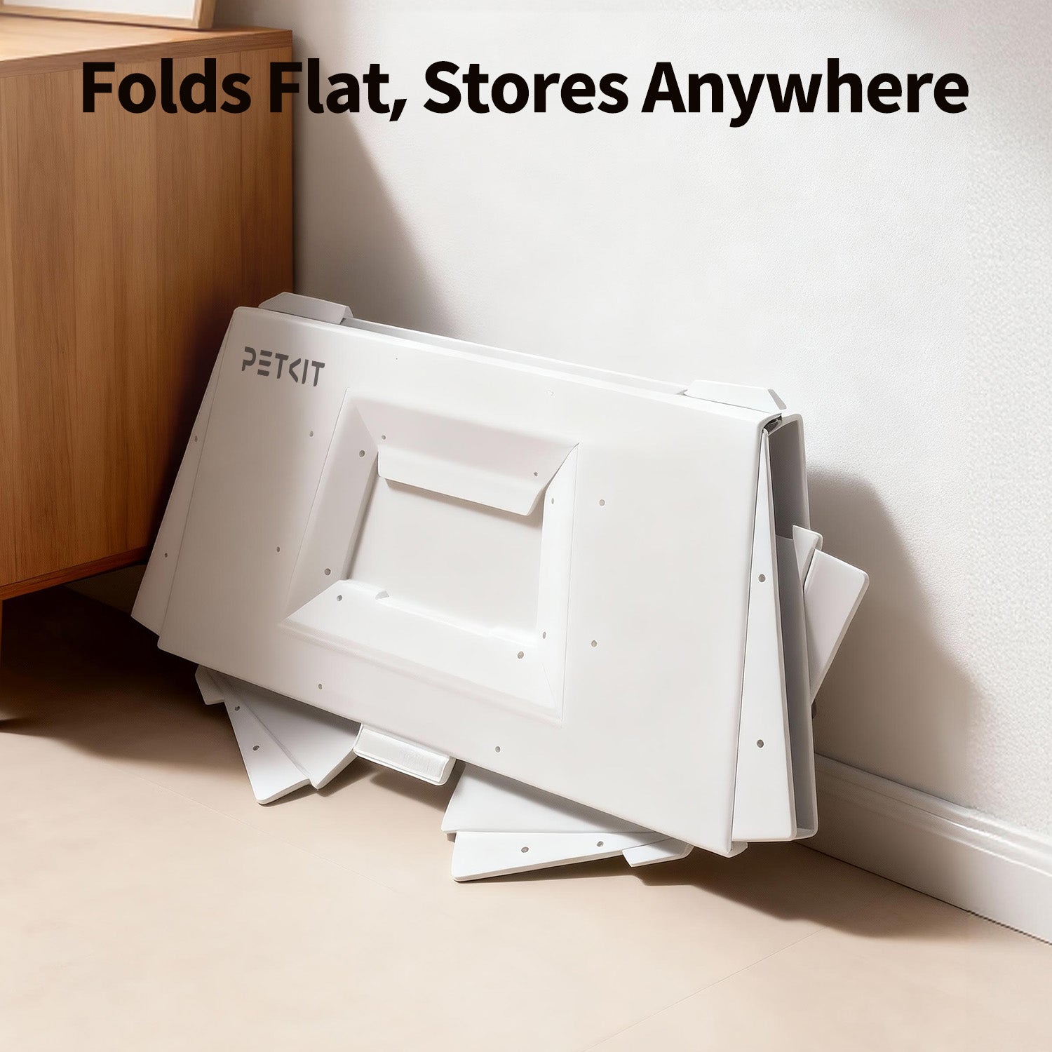 Front-Entry Hood folded flat and placed beside home furniture, showing how it can be stored easily in compact spaces