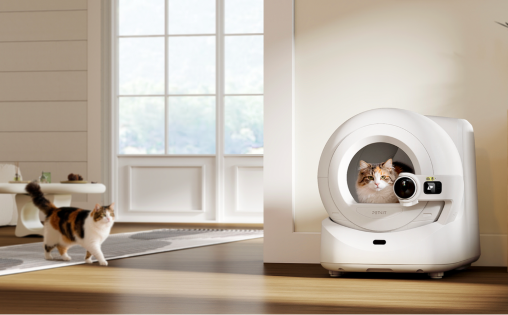 PETKIT Purobot Ultra automatic cat litter box in a modern living room with two cats