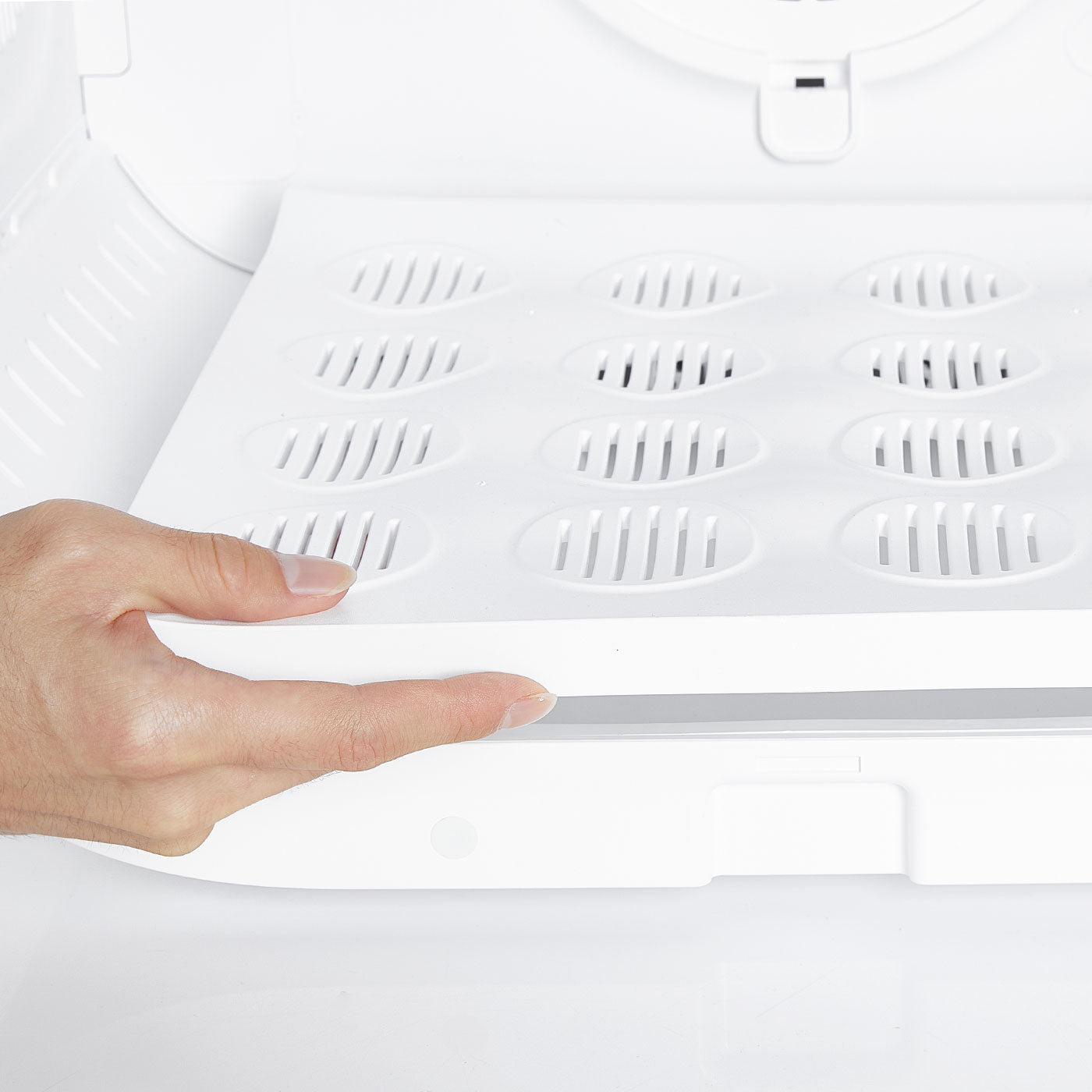 Removing the base tray of AirSalon Max Pro Pet Dryer Box for thorough cleaning and easy maintenance