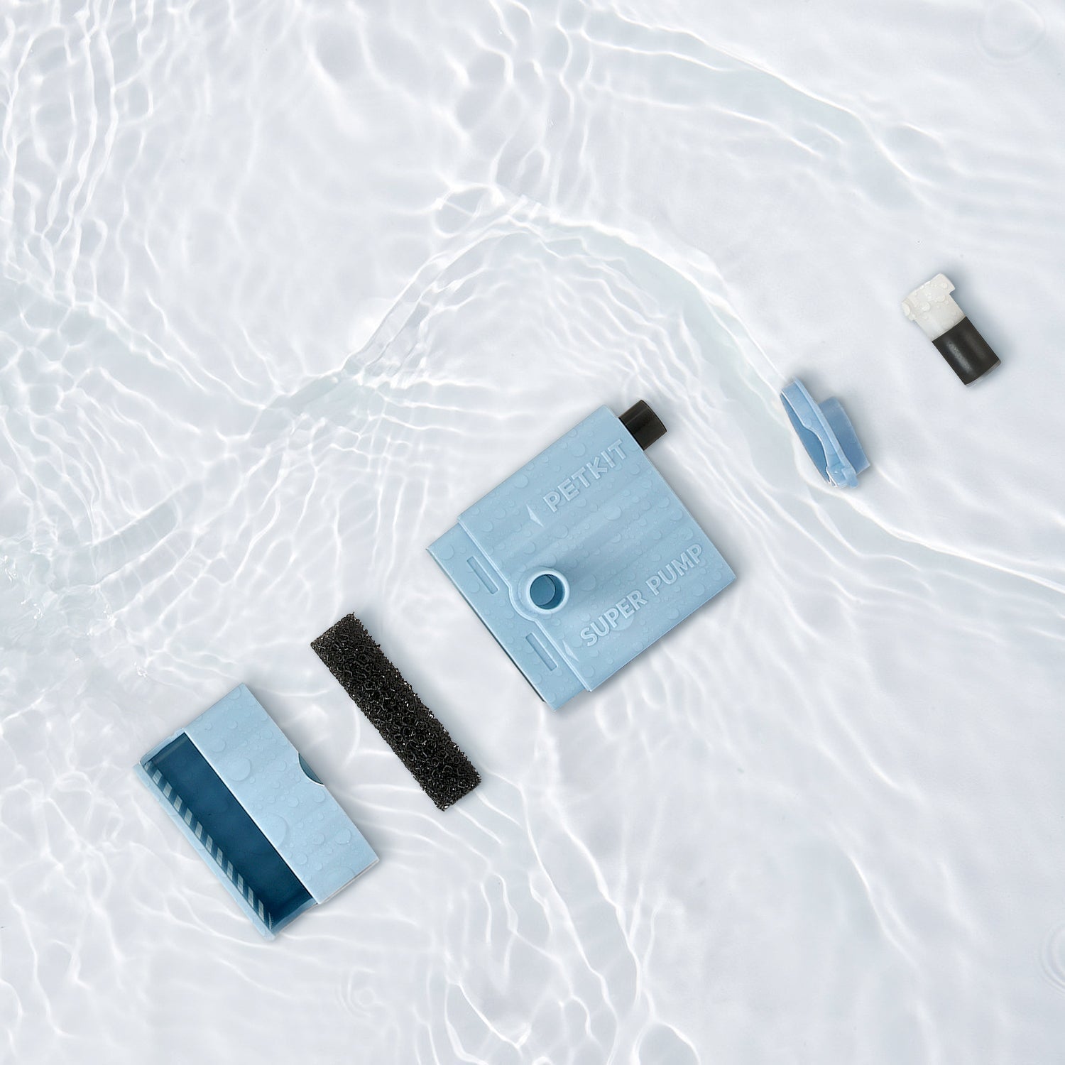 Wireless Water Pump shown fully detachable with individual components placed in clean water for easy and thorough cleaning